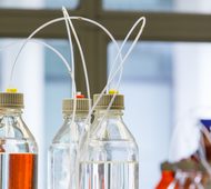 Close up clear and amber color bottle with plastic hose for High performance liquid chromatography - HPLC